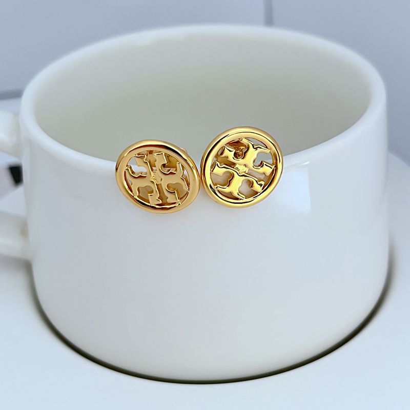 Round gold metal stud earrings with openwork logo medallion