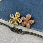 Gold-tone five-petal flower earrings with pink-purple crystal pavé petals
