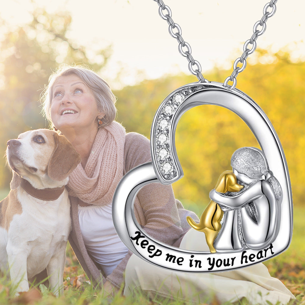 Heart-shaped pendant necklace with mother-and-child figures, gold accents and 'Keep me in your heart'