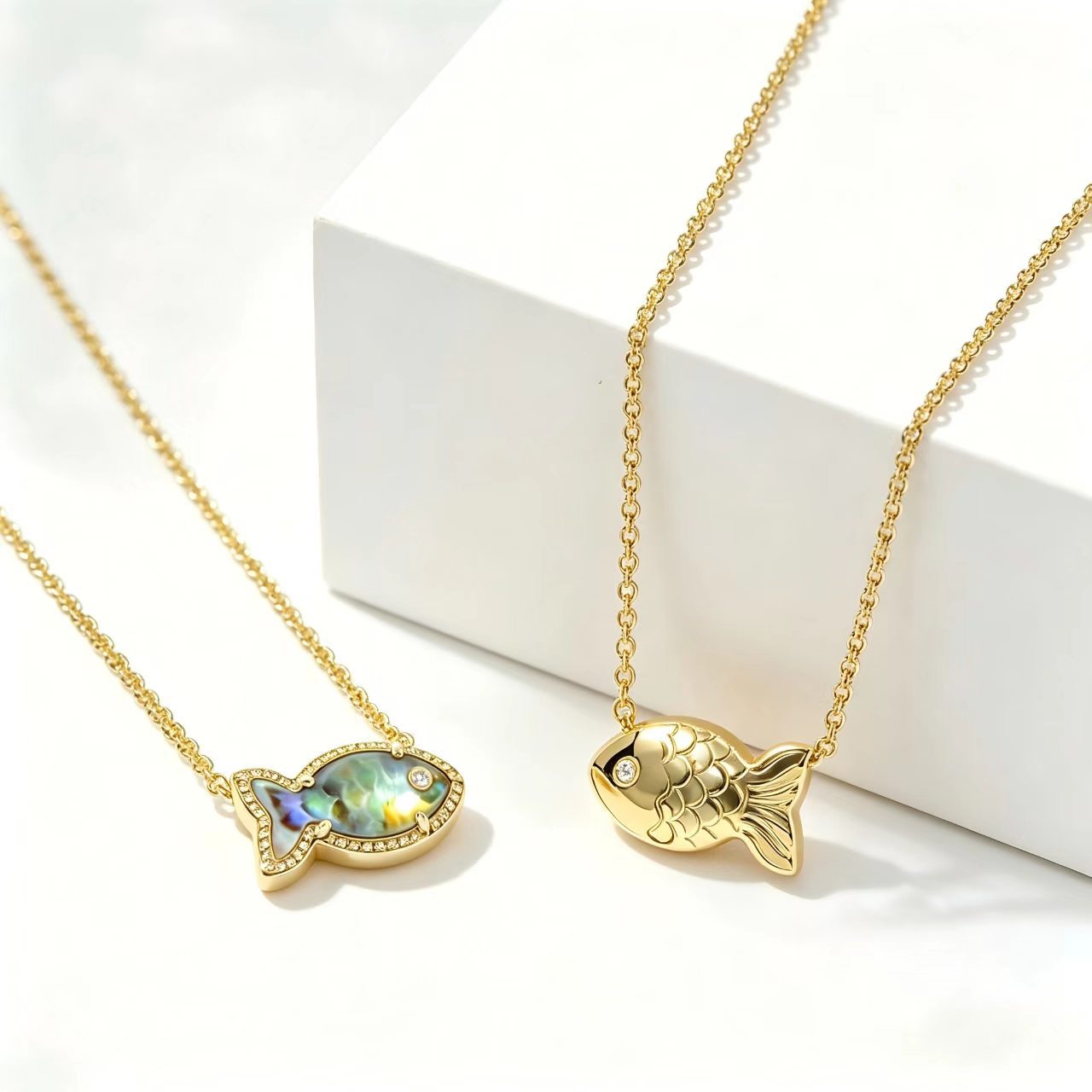 Fish-shaped iridescent pendant necklace, gold tone with small stones