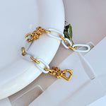 White chunky chain logo bracelet with gold-tone heart charm and quatrefoil accents
