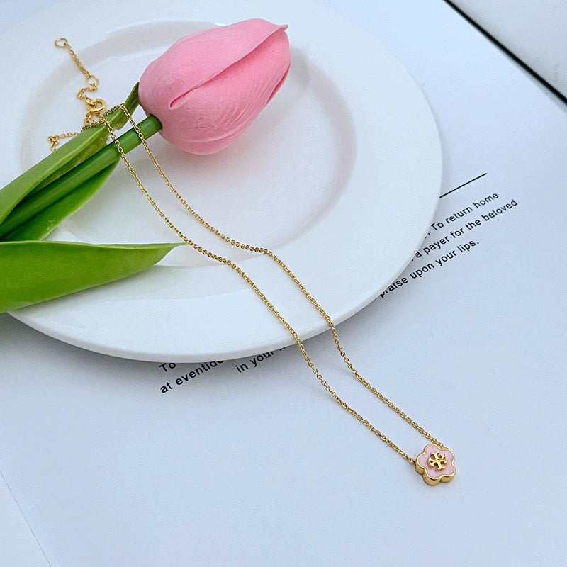 Tory Burch enamel floral pendant necklace with gold chain and pink floral clover charm
