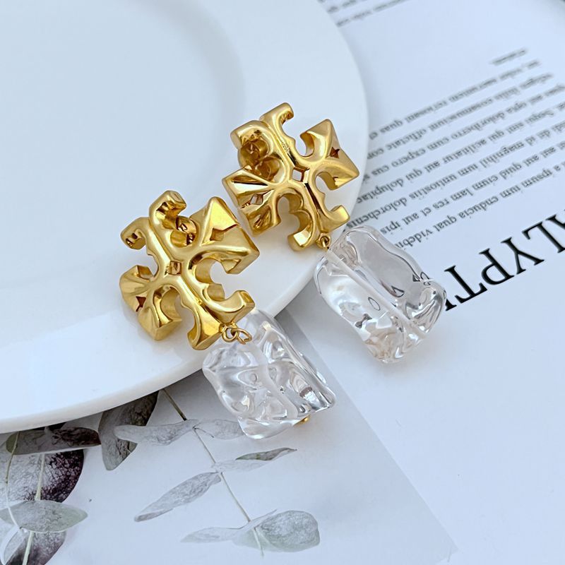 Irregular acrylic logo pendant earrings with gold-tone geometric cross details, clear/white mix