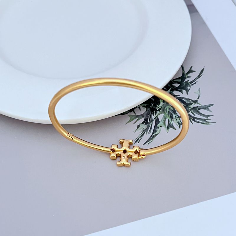 Openable gold bangle with diamond-set cross detail, side view