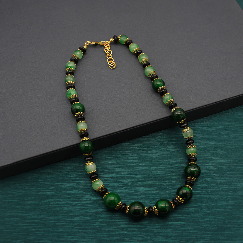 Vintage green glass bead necklace with gold-tone links and clasp
