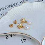 Gold-tone stud backs and logo pendant earrings with white freshwater pearls