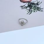 White gold clover flower metal ring with round diamond accents, open band