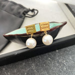 Gold square tag pearl earrings with white pearls and dangling chains