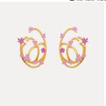 Pink enamel geometric hoop earrings with star and flower motifs