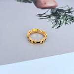 Gold-tone enamel geometric circle ring in open view, smooth bezel segments