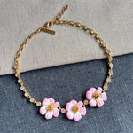 Enamel cherry blossom pendant necklace with pink flowers and gold links, round rhinestones
