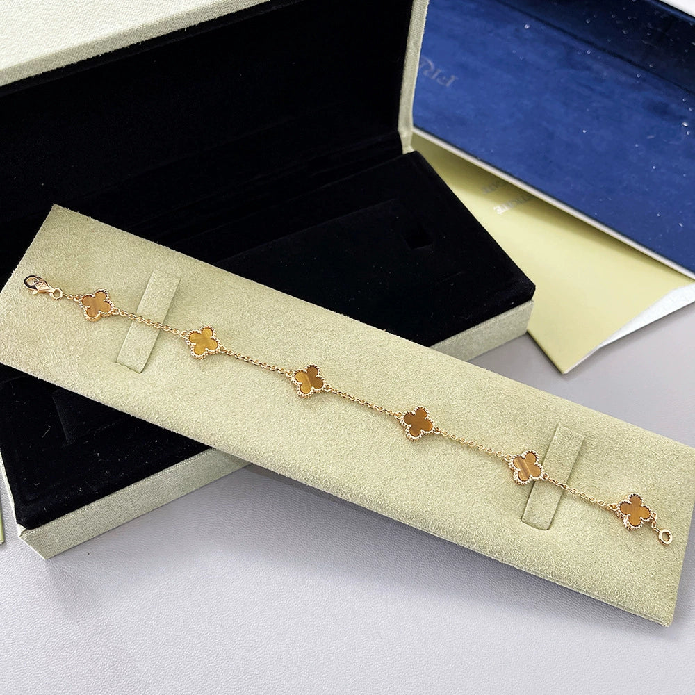Gold-tone clover bracelet with red agate flower links and four-leaf pattern, clasp