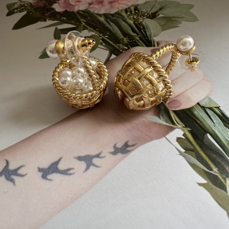 Gold basket stud earrings with white pearl beads and lattice woven design