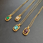 Gold-tone hammered square pendant necklaces with faceted stones in green, white, teal, and purple