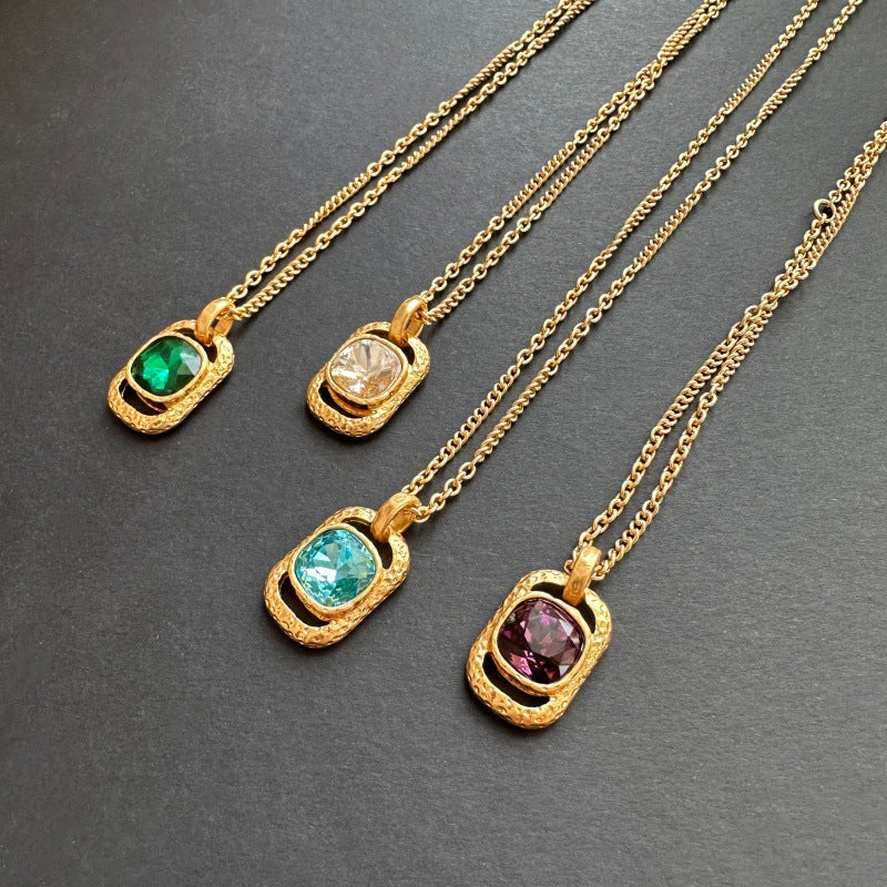 Gold-tone hammered square pendant necklaces with faceted stones in green, white, teal, and purple