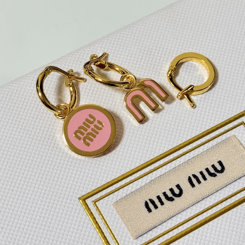 Three-piece enamel hoop earrings with pink round charm and gold-tone metal hoops