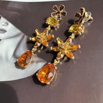 Yellow-orange crystal floral drop earrings with gold-tone pear teardrop charms