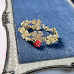Gold-tone four-leaf clover charm bracelet with ladybug bead and hinged clasp