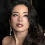 Dangling gold crystal earring with clear teardrop stones