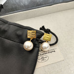 Gold square tag pearl drop earrings with white pearls and black cord ties