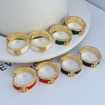Enamel hoop earrings set: gold tone with green, red, black, and white bands