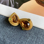 Teardrop crystal stud clip-on earrings with gold heart setting and brown stones