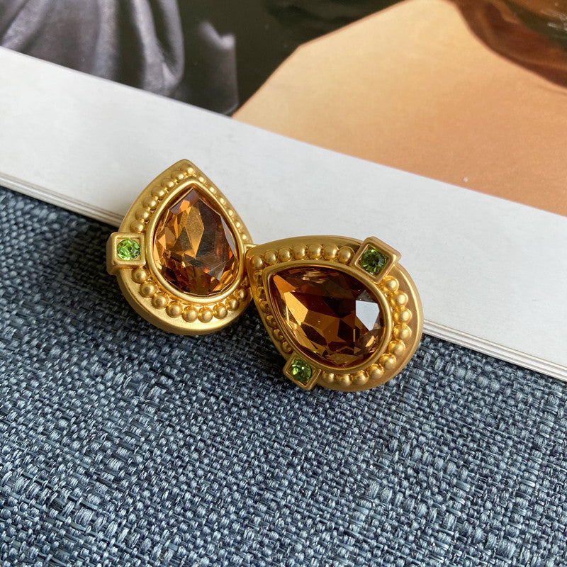Teardrop crystal stud clip-on earrings with gold heart setting and brown stones