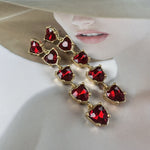 Red heart-shaped crystal drop earrings with gold-tone links