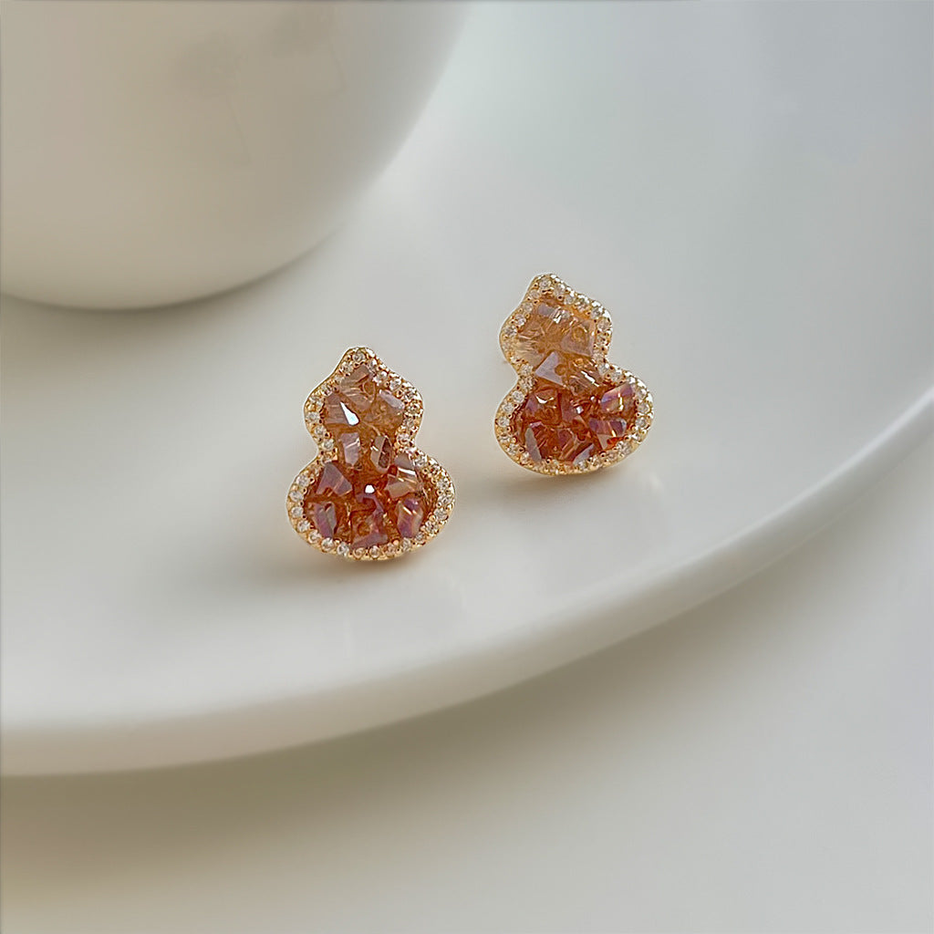 Amber orange gourd crystal stud earrings with rhinestone surround, gold-tone finish