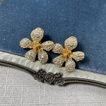 Five-petal diamond flower earrings in gold tone with clear pavé stones