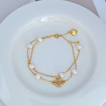 JIMMY JEWELRY 02 gold double-row bracelet with heart charm, pearls, and rhinestone bar