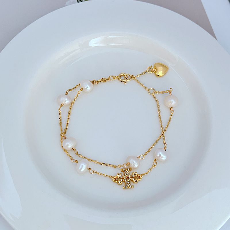 JIMMY JEWELRY 02 gold double-row bracelet with heart charm, pearls, and rhinestone bar