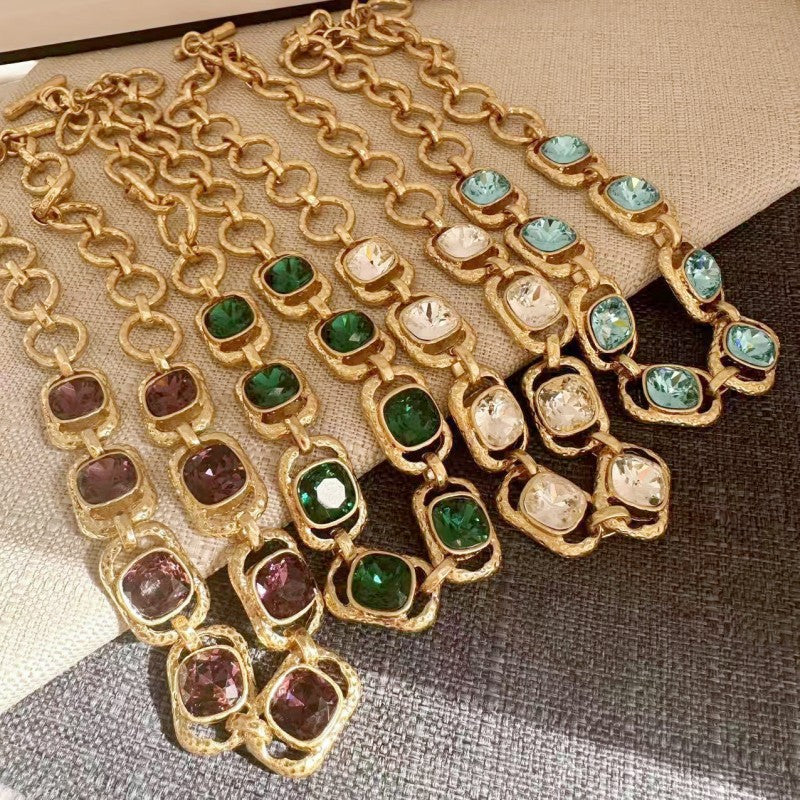 Gold link crystal necklace with assorted faceted stones, including green and clear