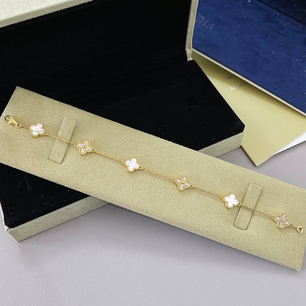 Gold-tone clover bracelet with white agate flower links and four-leaf motif chain