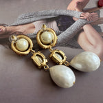 Faux pearl drop earrings with gold-tone hoop frames and dangling pearl drops