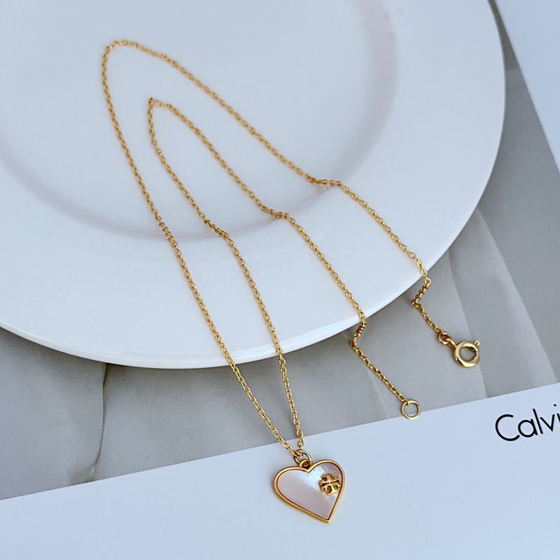 Gold-tone heart-shaped shell pendant necklace with small links and round clasp