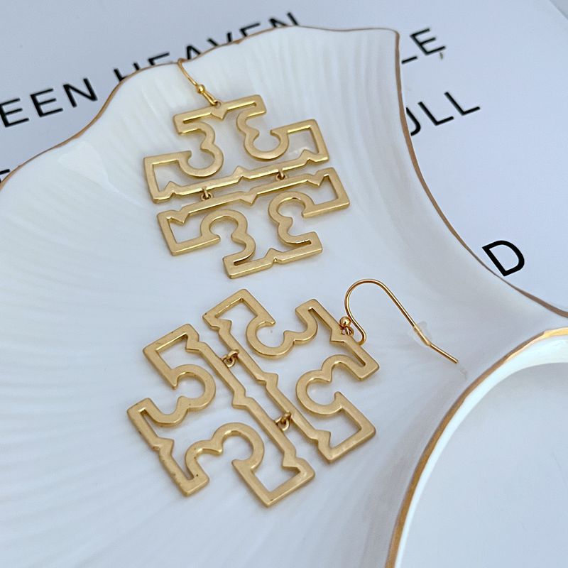 Gold minimalist logo drop earrings with layered geometric cutout sections and hooks
