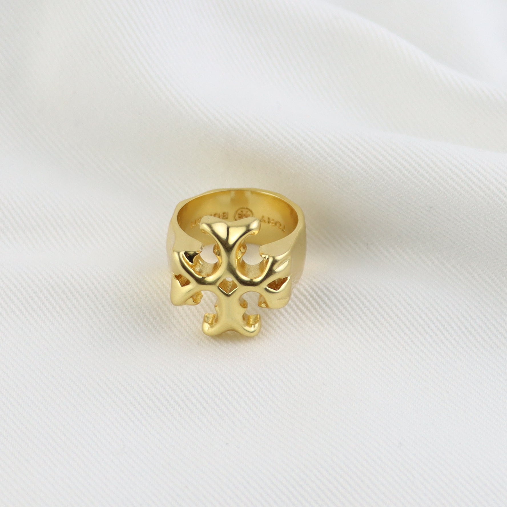 Matte gold vintage ring, top view showing cutout logo on the band