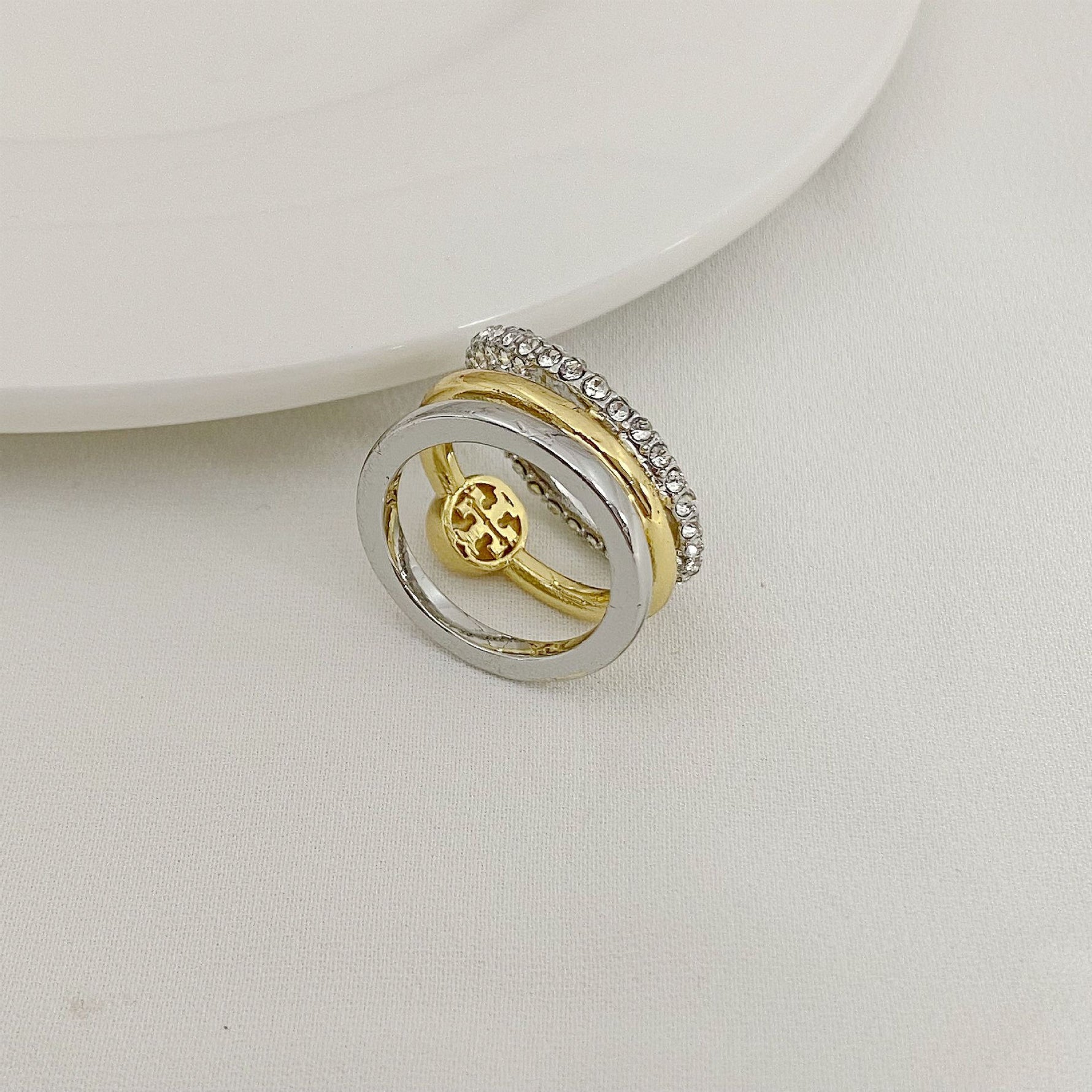 Two-tone three-band metal ring with gold and silver stacked bands
