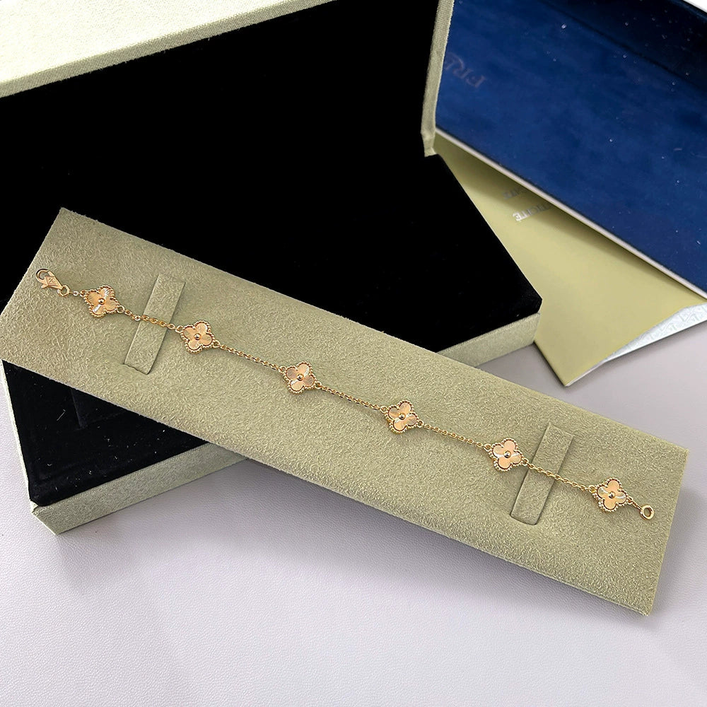 Rose-gold clover bracelet with red agate flower links and four-leaf motif chain
