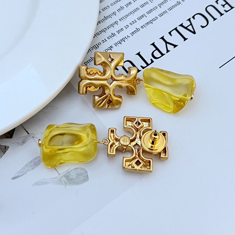 Yellow irregular acrylic logo pendant earrings with gold-tone cross charm and inset round detail