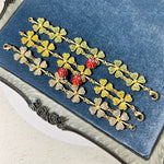 Ladybug and four-leaf clover charm bracelets set on display, gold-tone glitter charms
