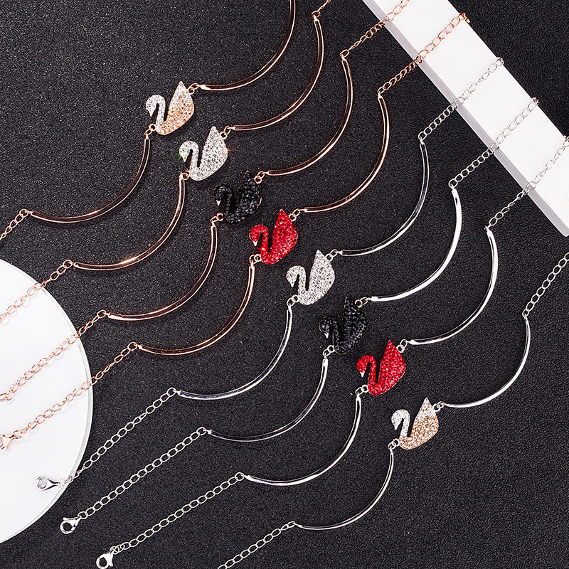 Assorted swan charm bracelets with pavé stones and red or black accents