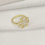 Gold openwork logo ring with geometric centerpiece and slim band