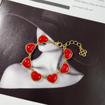 Red matte heart bracelet, gold-tone chain with red heart charms