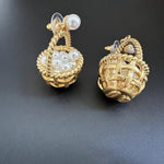 Gold basket stud earrings with pearl clusters and braided rope detail