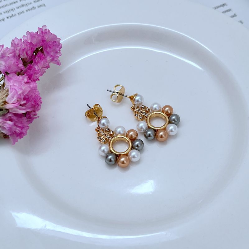 Gold-tone round drop earrings with openwork ring, white pearls, and mixed bead clusters
