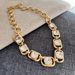 Gold link necklace with clear faceted crystal oval stations