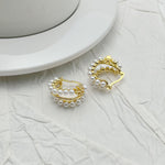 Gold-tone faux pearl hoop earrings with decorative outer bezel