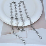 White gold four-leaf clover sweater chain with linked clover charms and clasp